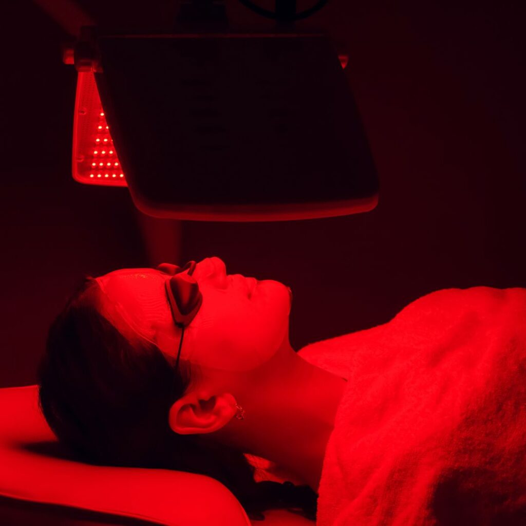 woman under red light lamp