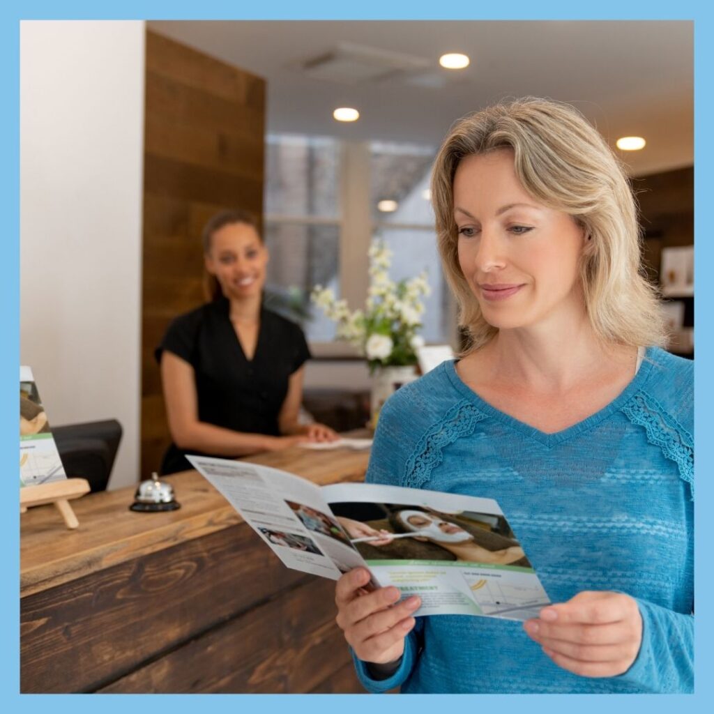 woman at wellness center reading brochure